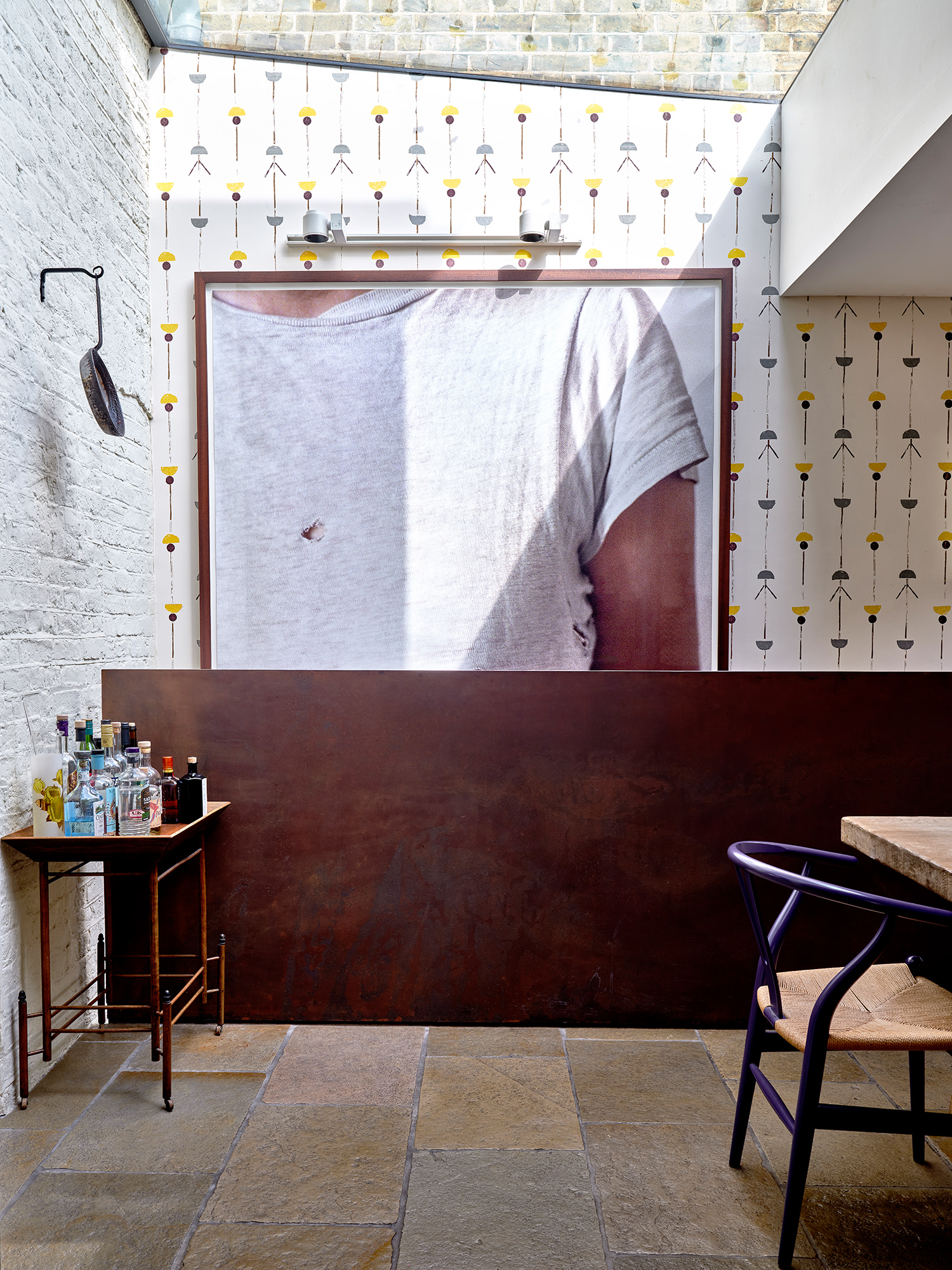 The kitchen with a Sarah Lucas self-portrait and a battered pan hanging on the wall, which was a present from Giorgio Locatelli
