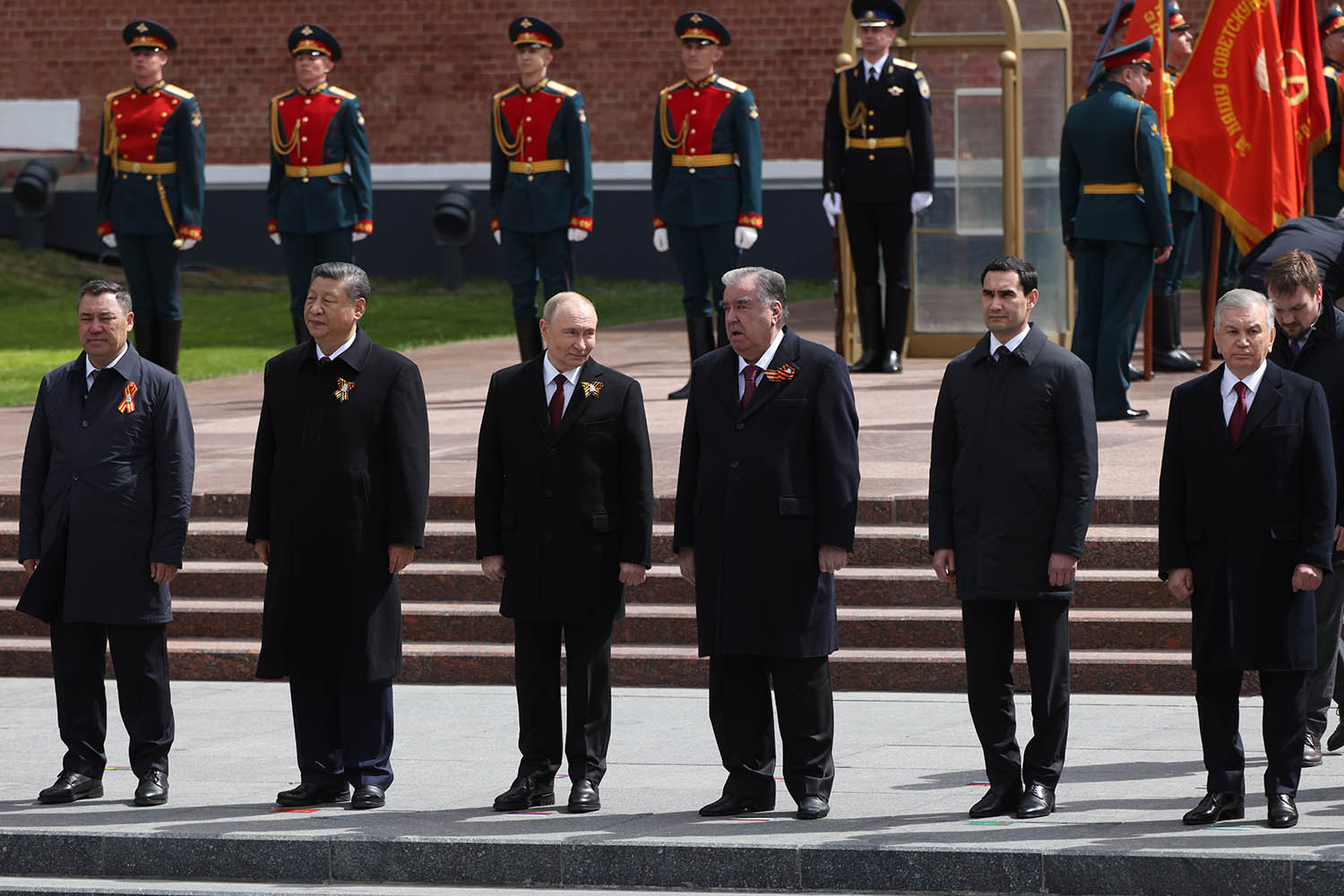 Putin, centre, is flanked by ﻿﻿VIP guests during the wreath-laying ceremony at the tomb of the unknown soldier by the Kremlin Wall on Friday.