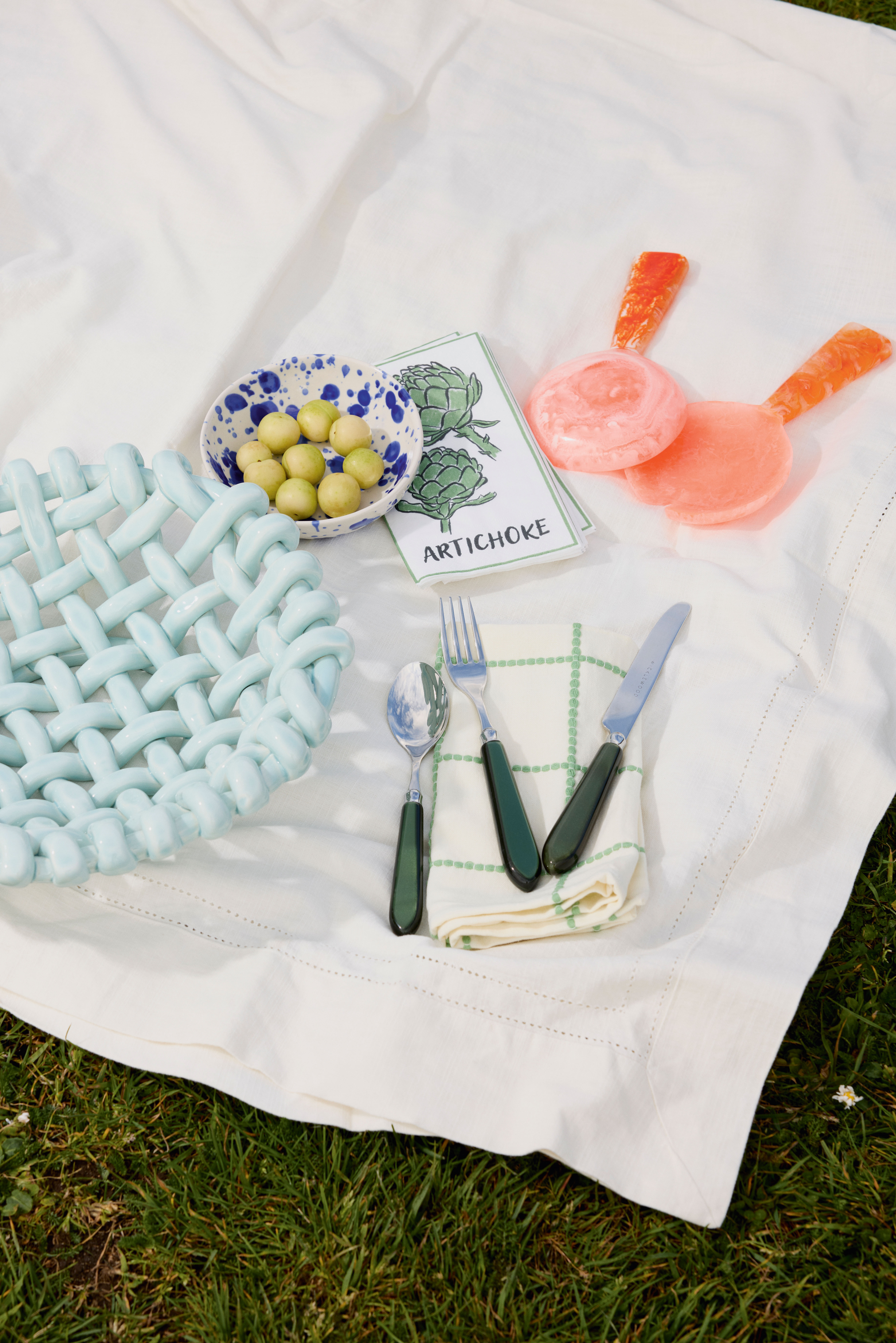 Weave bowl £169, Late Afternoon; Stoneware bowl  £7.99, and  artichoke  paper napkins  £2.49 for 15, H&M; Salad servers £26.50, Oliver Bonas; Cotton napkin  £10 for 4, M&S;  Cutlery £166 for 8-piece set, Wicklewood; Tablecloth  £69.99, Zara
