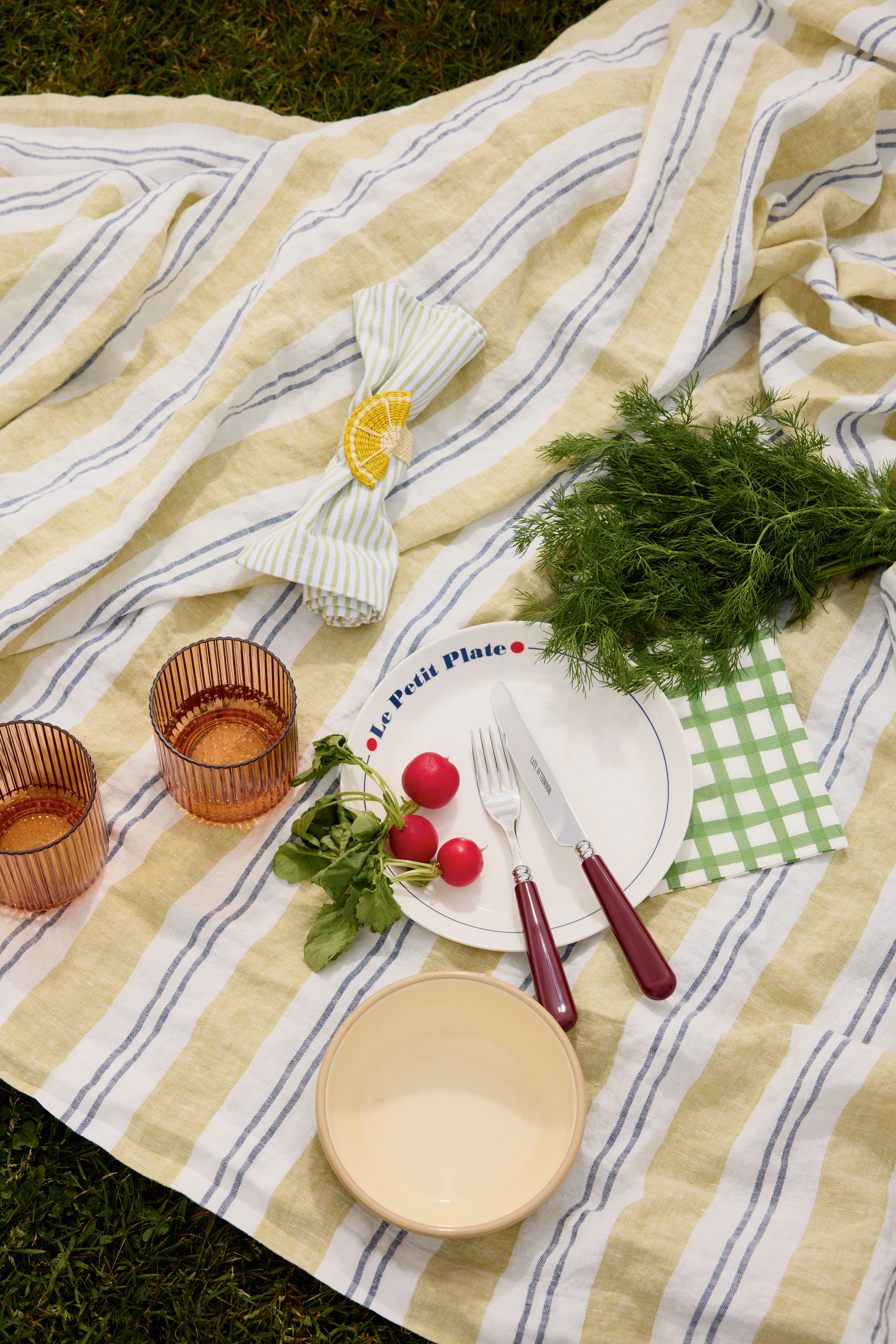 Tumblers £10 for 4, Habitat;  Striped napkins £10 for 4, John Lewis;  Napkin ring £15, Arket ; Plate £72 for 4, Jonathan Adler;  Bowl  £12.50, Toast;  Knife and fork £26 for set, Late Afternoon; Check paper napkin £2 for 20, John Lewis; Table linen  £125, Toast
