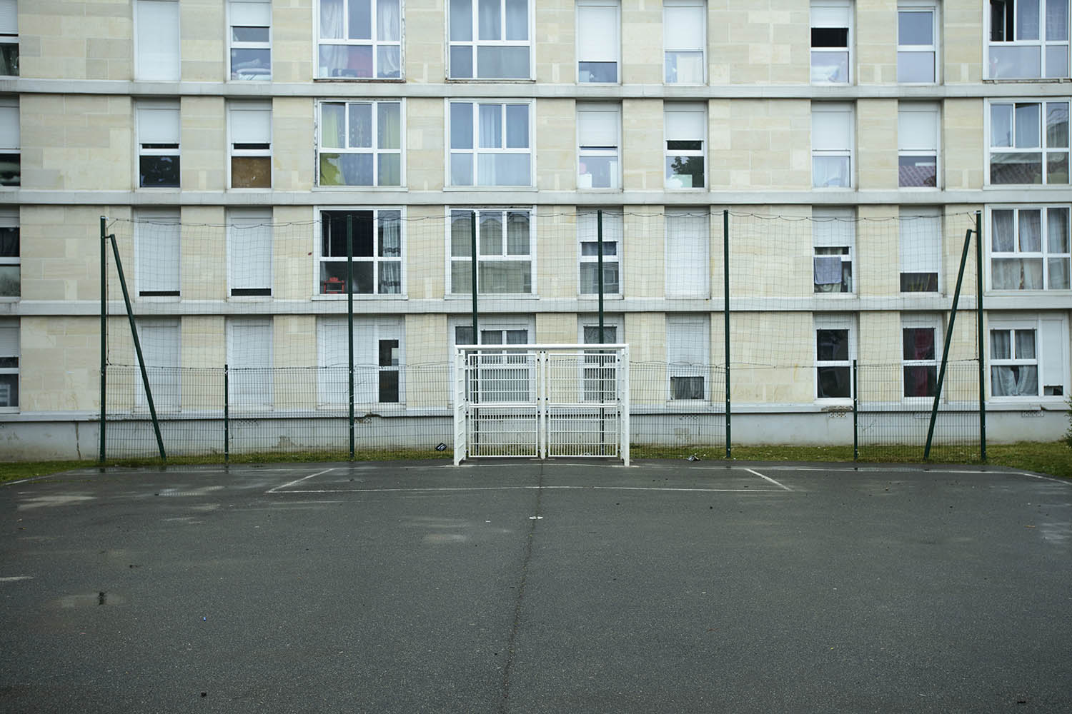 A football ground in the courtyard of a housing block in the Paris suburb town of Sarcelles, France
