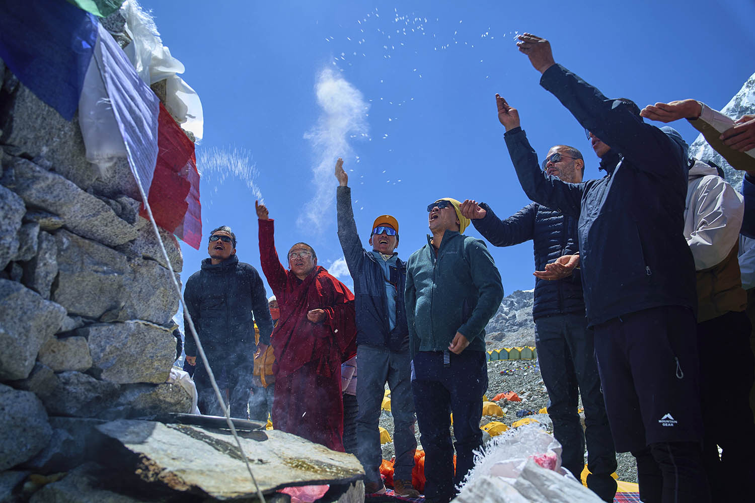 Kami Rita Sherpa, third left, holder of the record for most ascents, takes part in prayers.