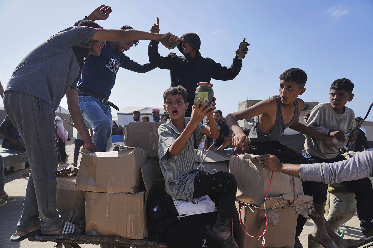 Palestinian children in Rafah rush to collect food and aid packages. AP