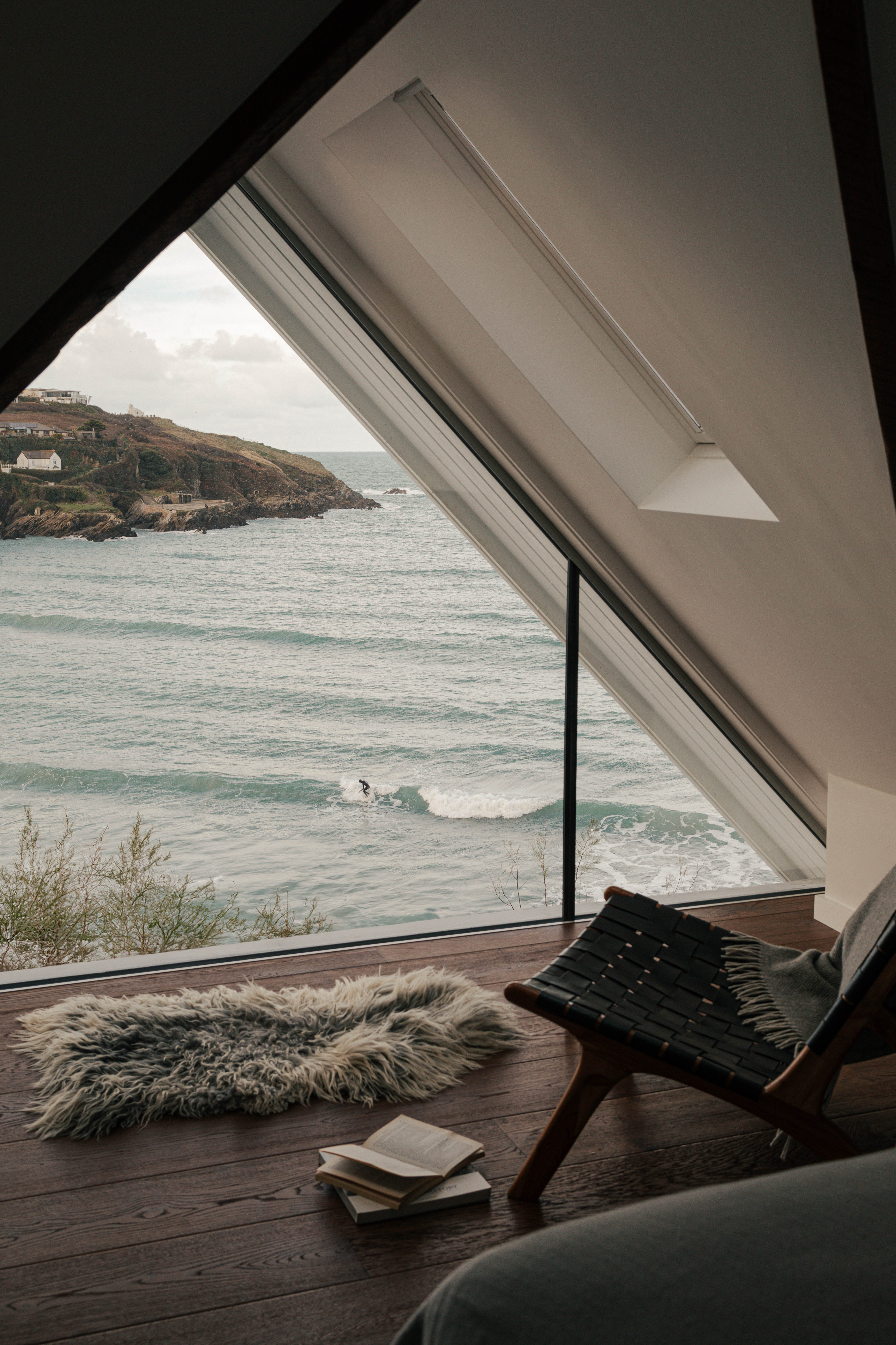 Views take in the mainland and surfers below