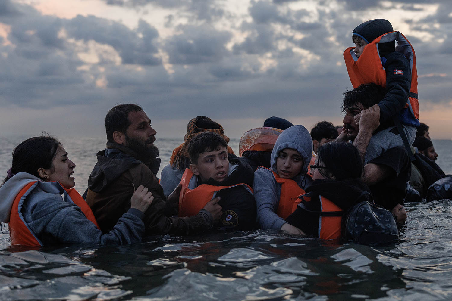 Anxious families wait for a place on a boat across the Channel