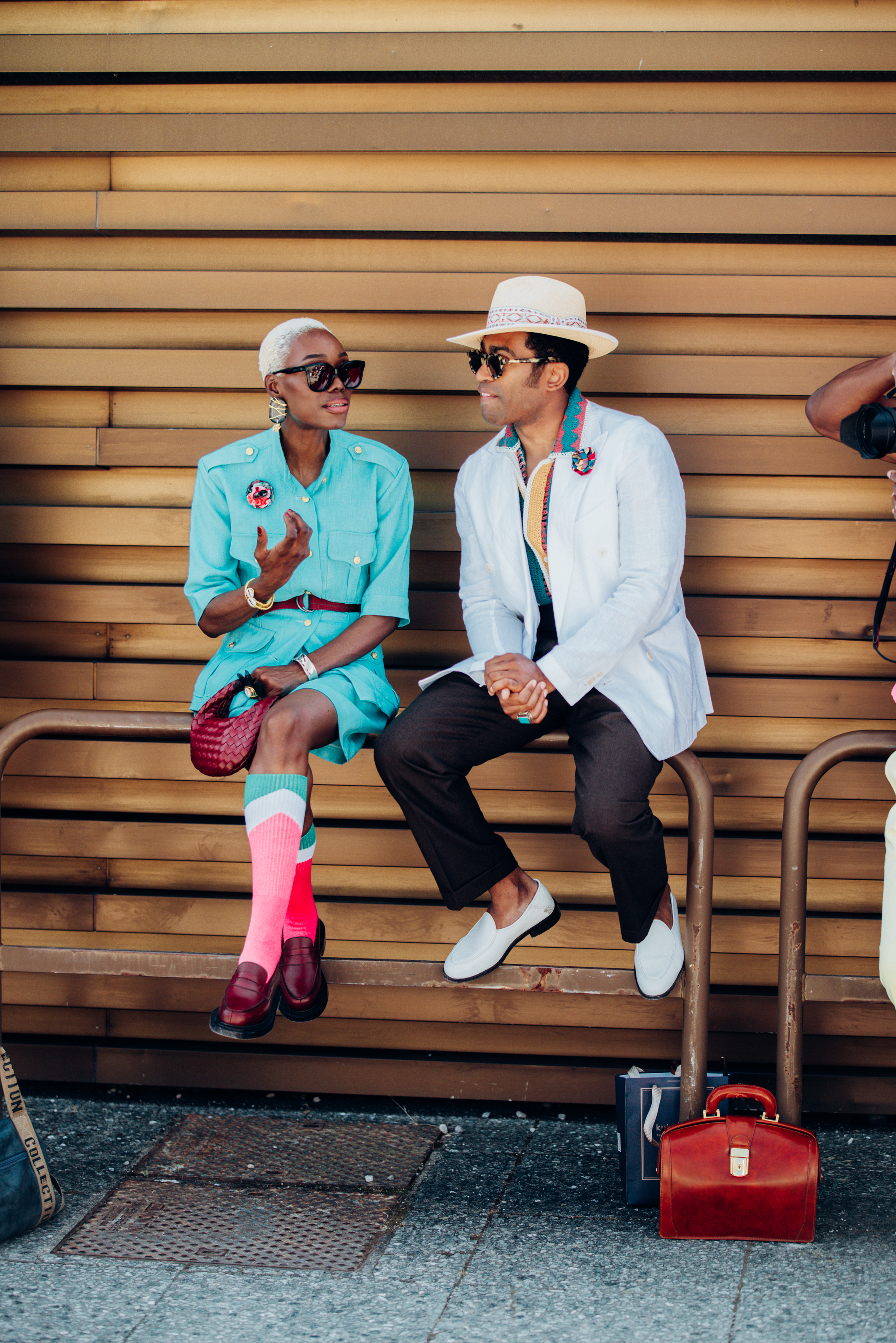 Arlene Peleka, influencer, accessories her mint safari suit with a My Boutonniere corsage and JM Weston shoes. Designer Jordan Esthete adds a pop of colour to his look with a crocheted polo shirt