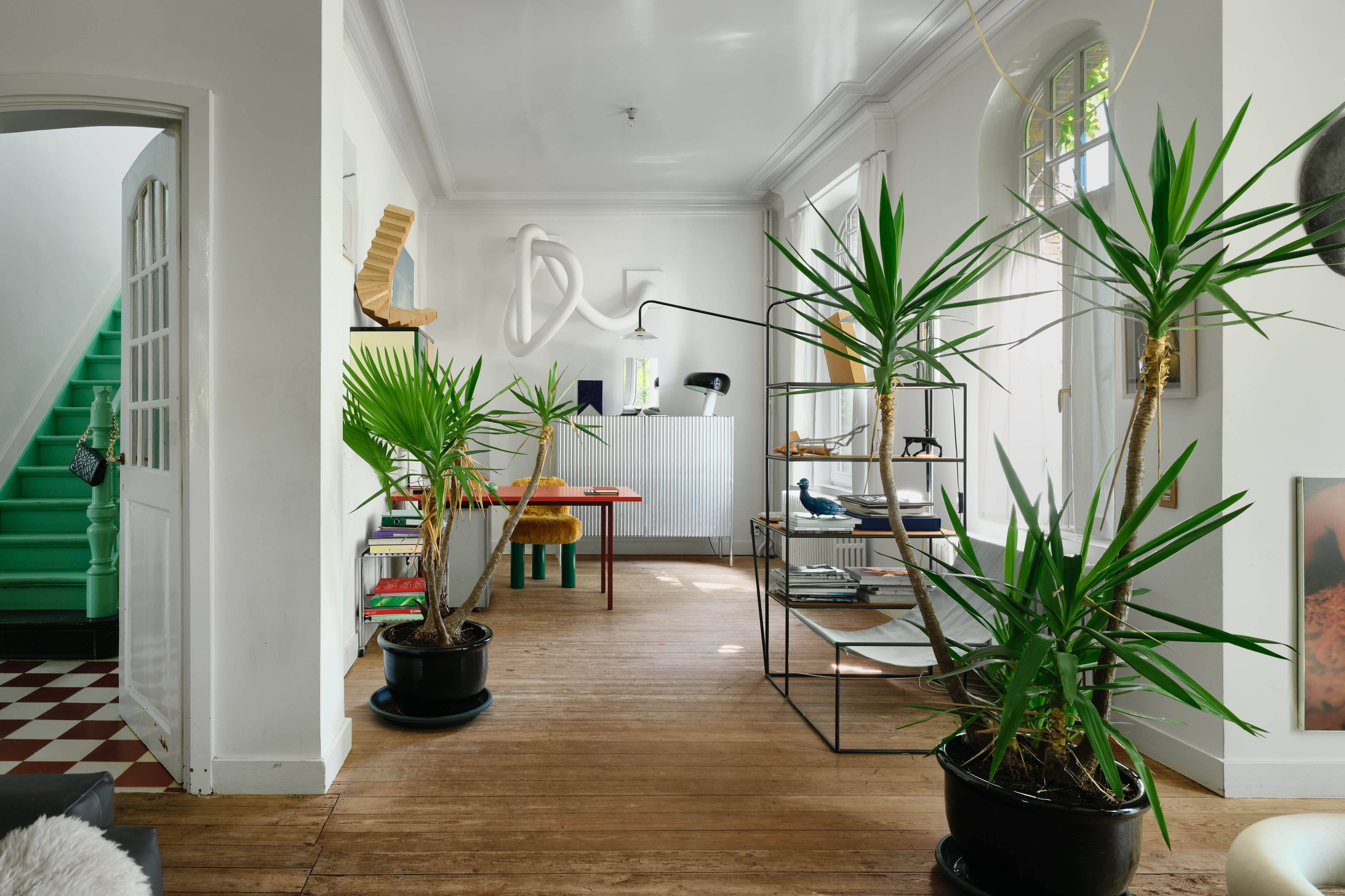 Room to grow: the wide entrance hall with green-painted wooden stairs heading to the first floor