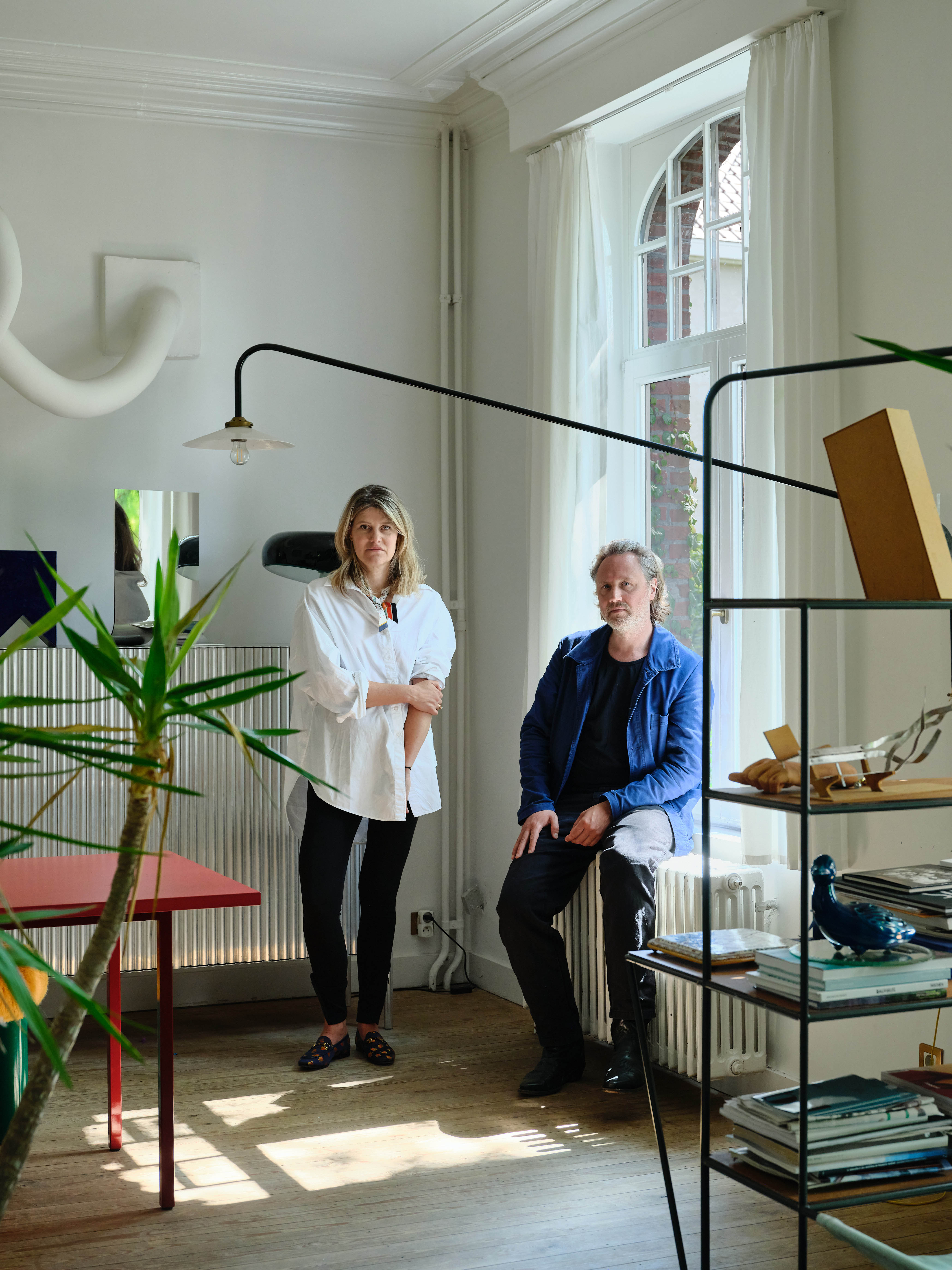 Design duo: the couple in their sitting room with some of their designs