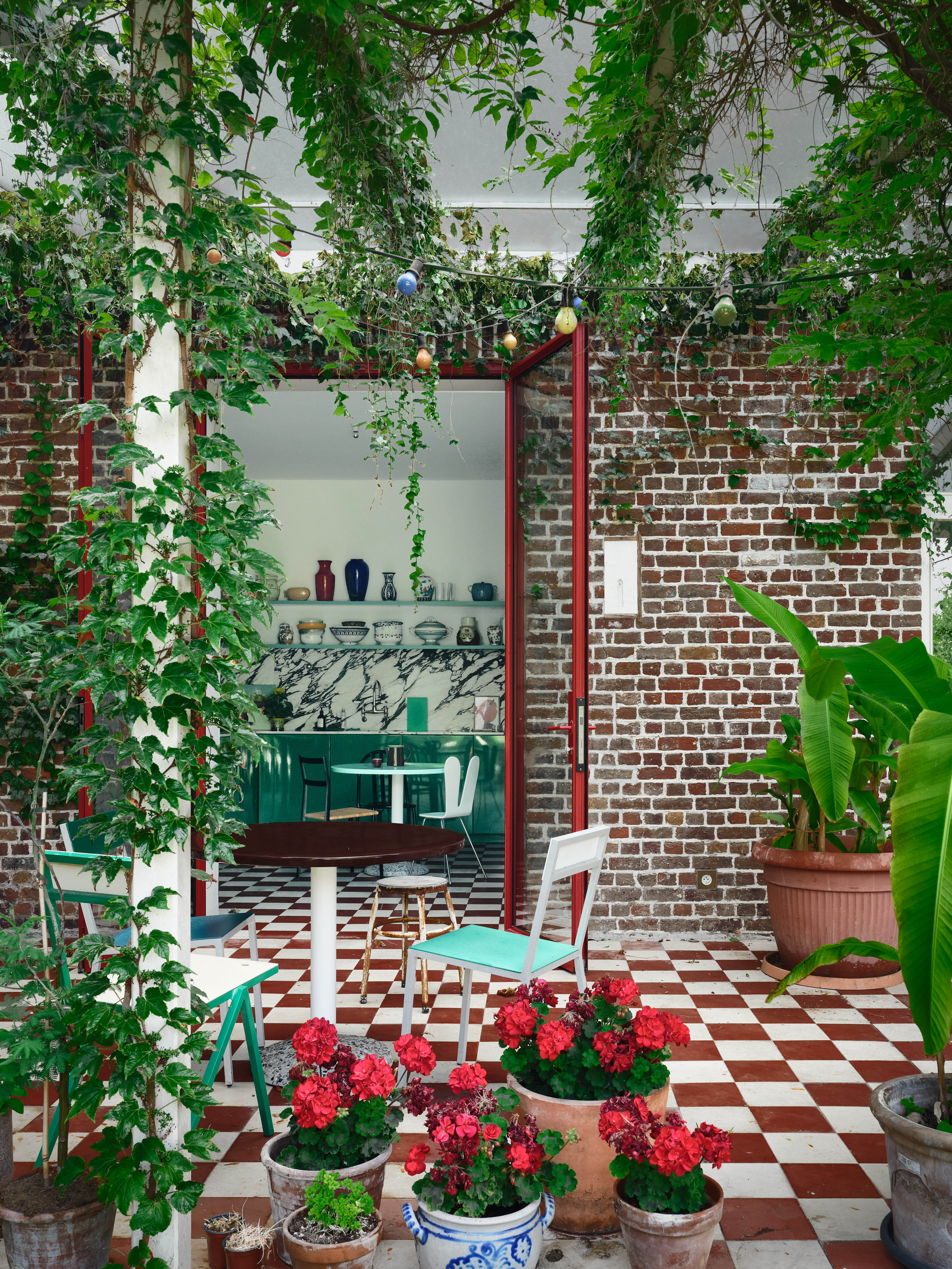 On the tiles: the chequered floor runs through to the kitchen and out into the garden