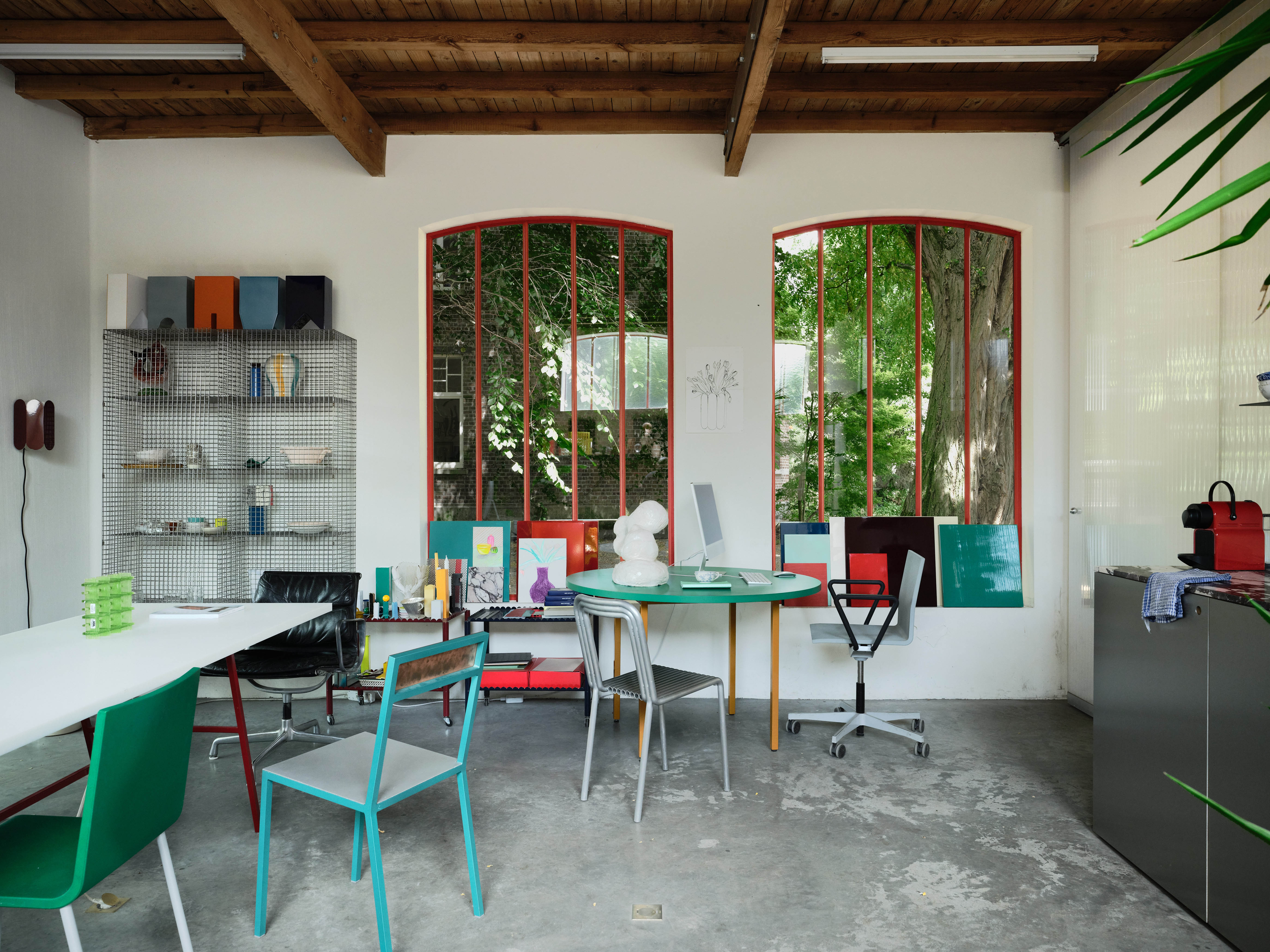 Concrete thinking: the studio, a vast former orangery with red-framed arched windows, is used as both a studio and showroom for tables and chairs