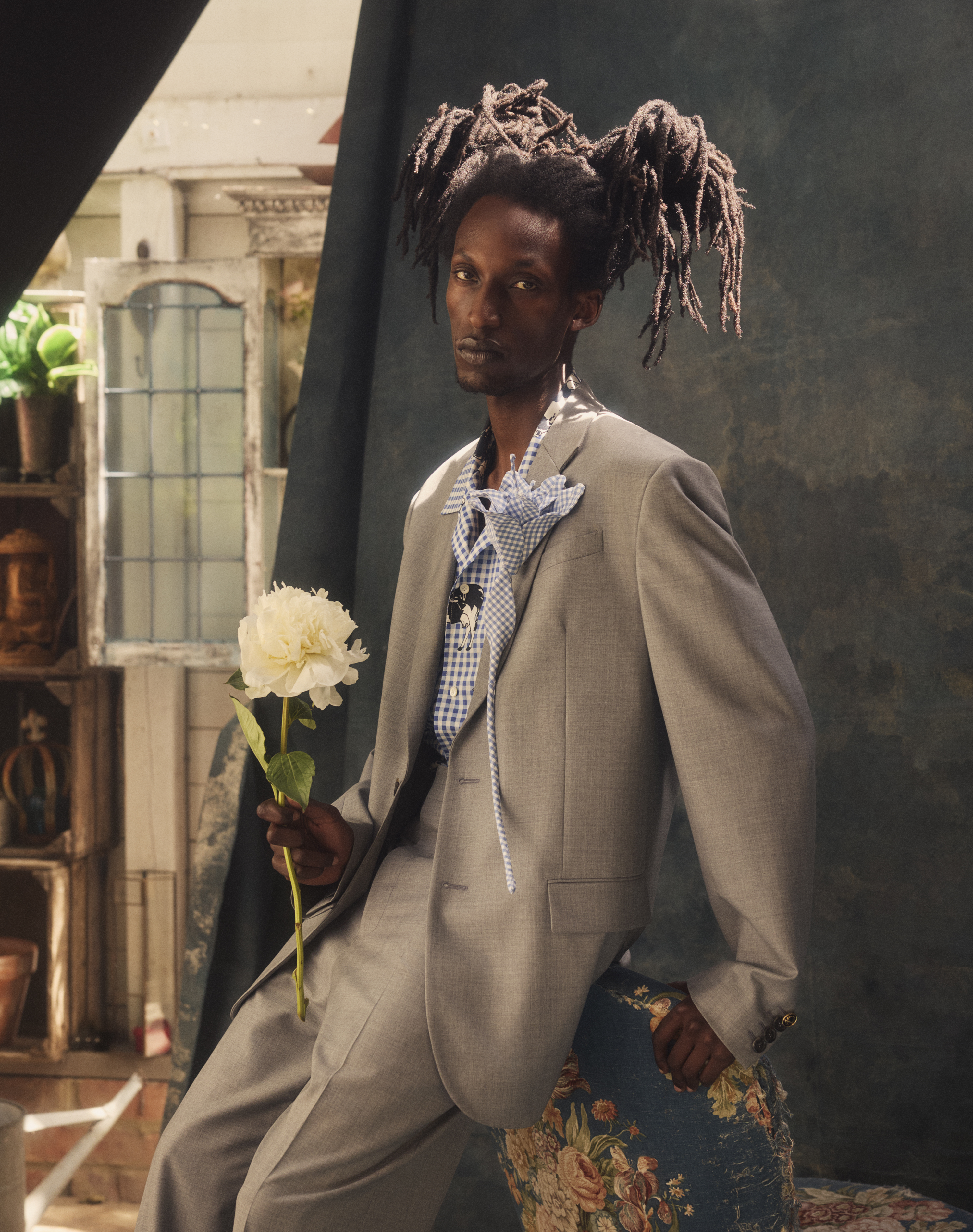 Suit and shirt both by Moschino. Gingham Lily brooch by Timothy Li