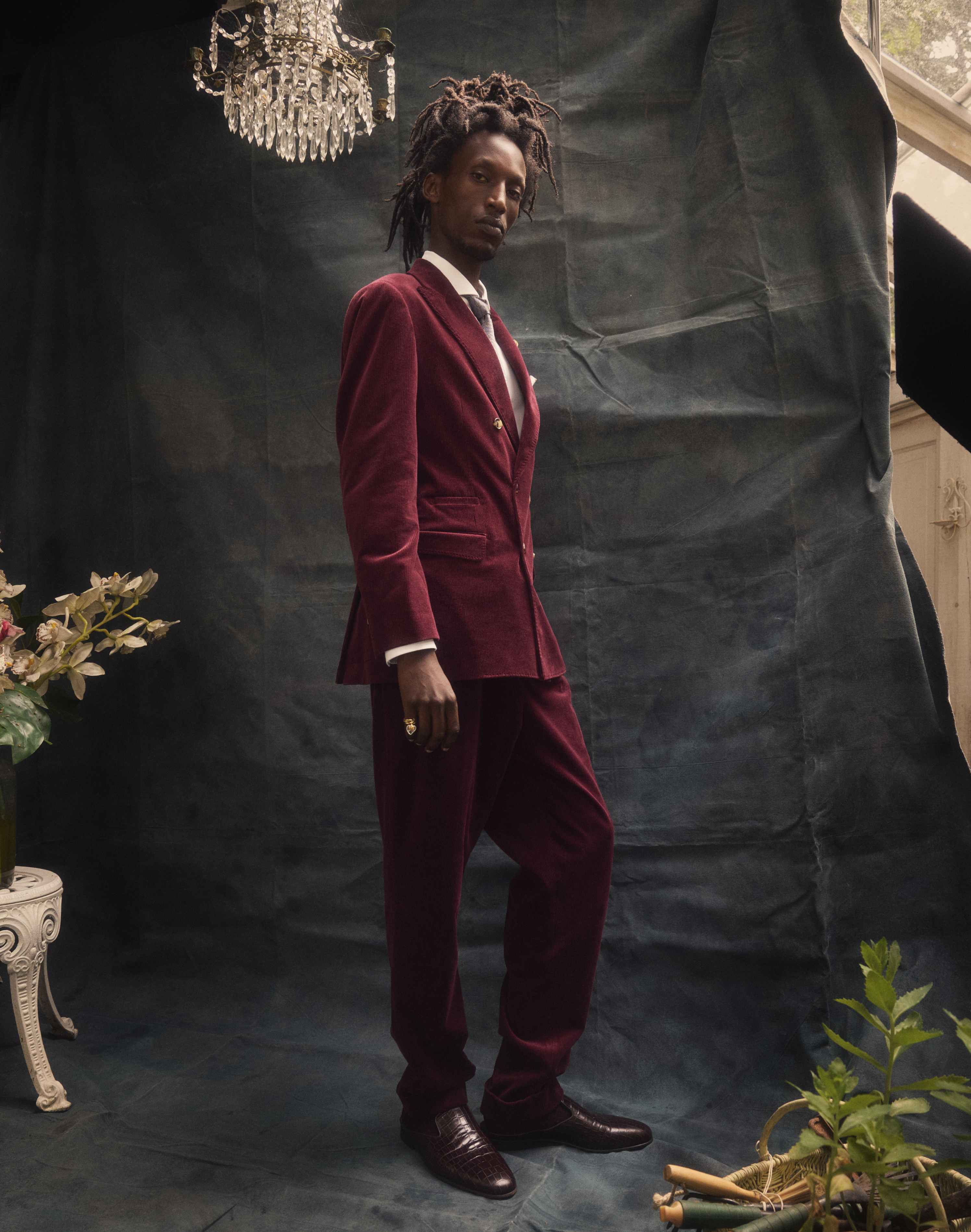 Double-breasted velvet suit, shirt and silk tie all by Brunello Cucinelli. Mules by Manolo Blahnik. Crystal ring by Goossens Paris