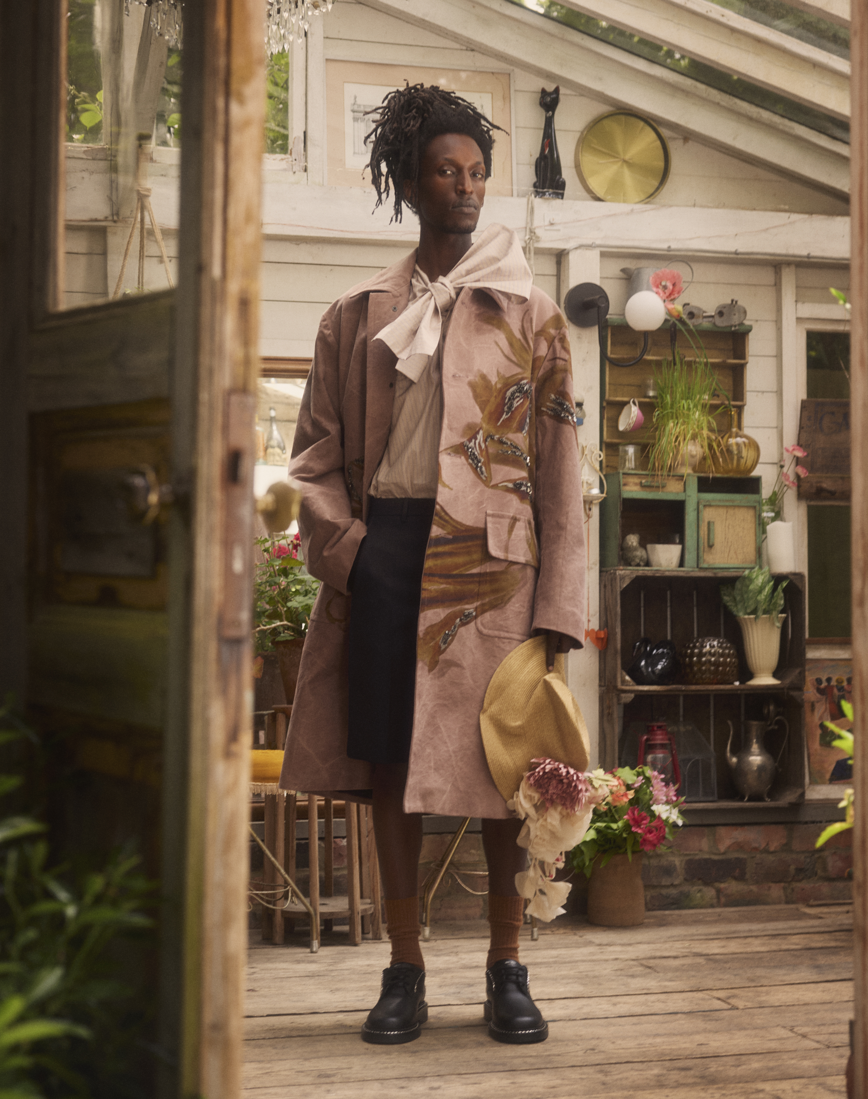 Coat, shirt and shorts all by Dries Van Noten. Socks by the London Sock Company. Derby shoes by Jimmy Choo. Crushed hat by Toast. Flowers on hat by VV RouleauxGrooming: Federico Ghezzi using Bumble and Bumble. Fashion assistant: Sam Deaman. Lighting: Michael Furlonger. Digital technician: Damian Flack. Photographer’s assistant: Georgie Fenney. Model: Eden at Premier.