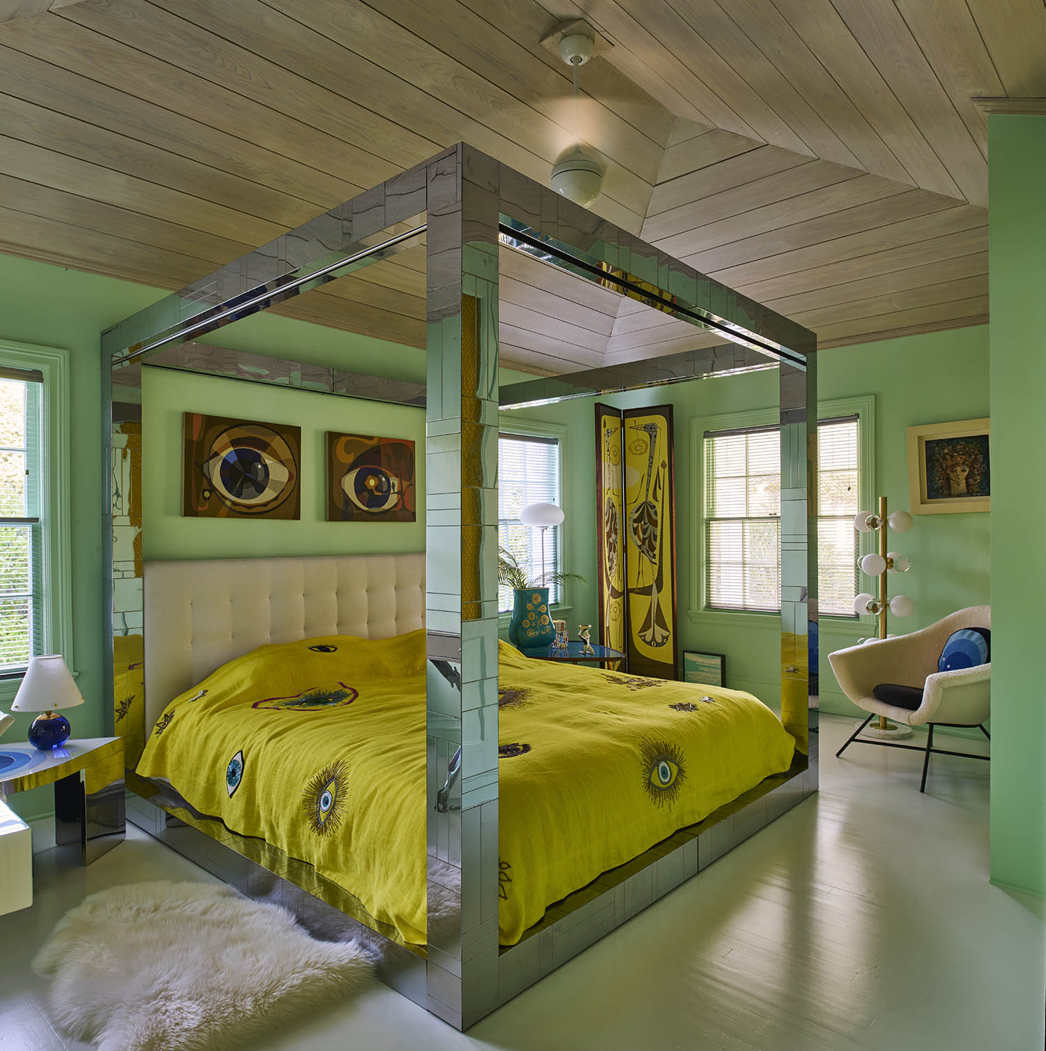 All that glitters: the guest bedroom with vintage chrome bed by Paul Evans, and eye paintings and screen by Jean-Paul Philippe