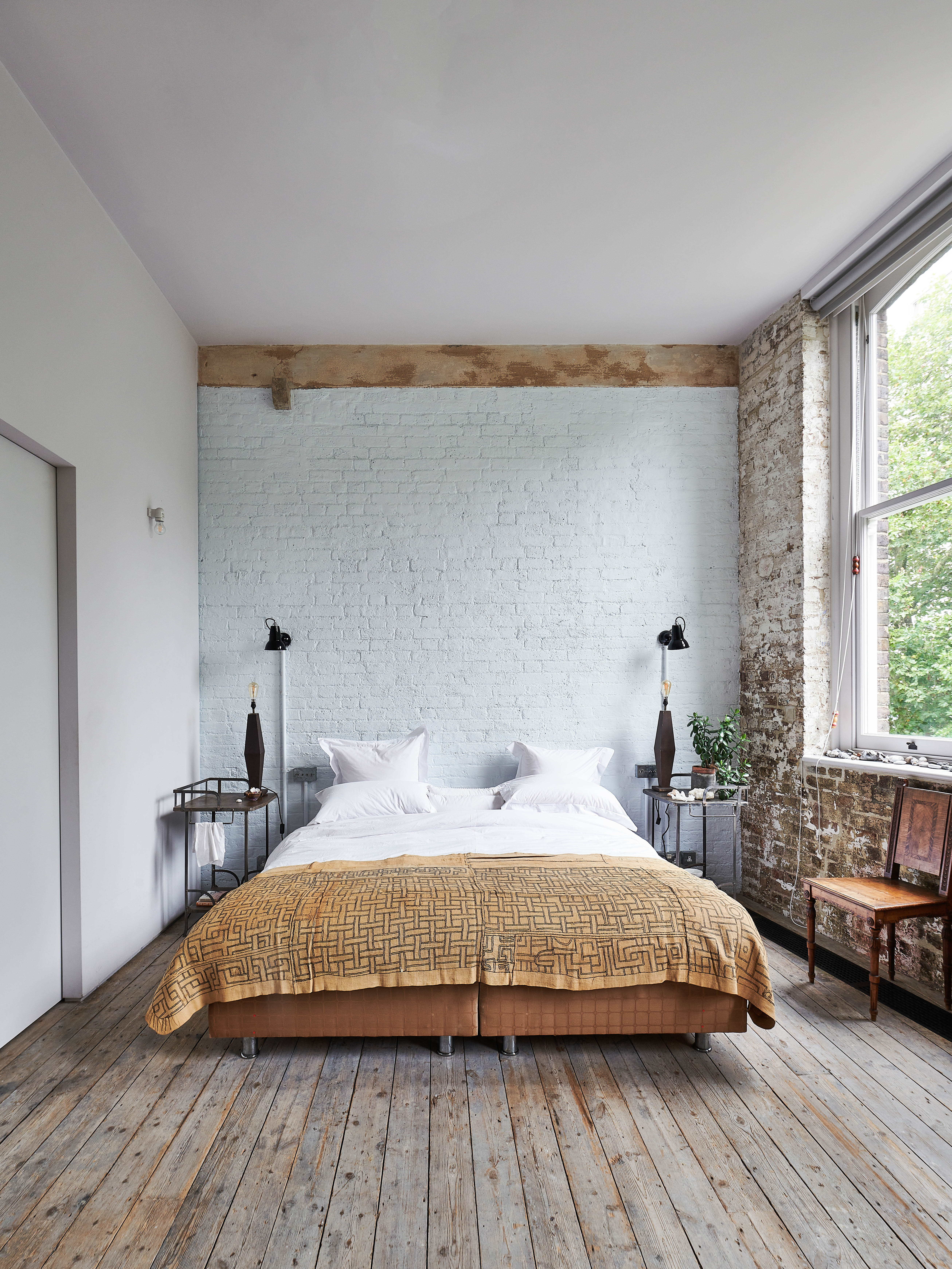 And so to bed: one of the bedrooms with exposed brick walls and large window on to the garden