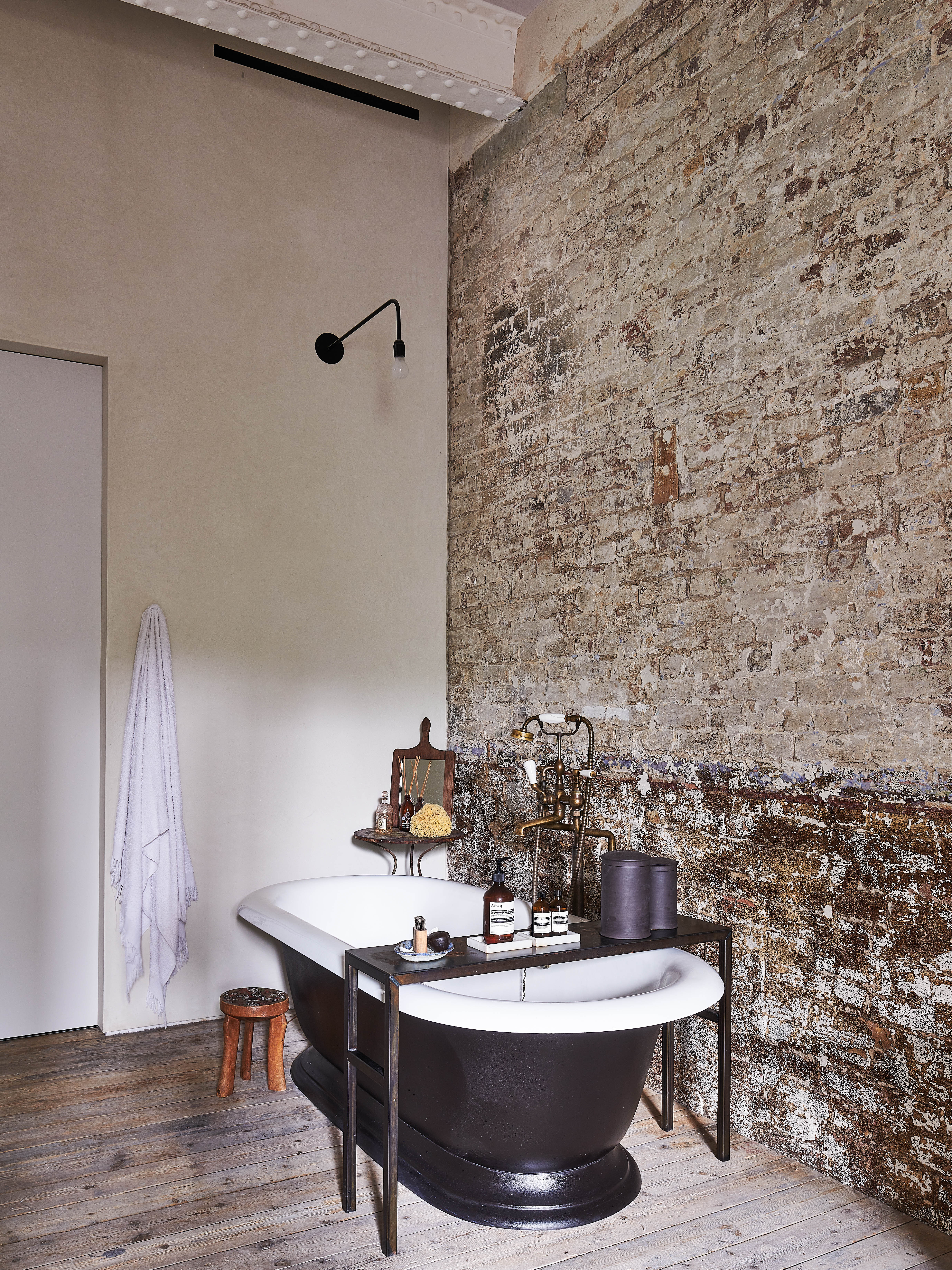 Deep soak: Lucille’s bathroom with exposed brick walls and giant tub